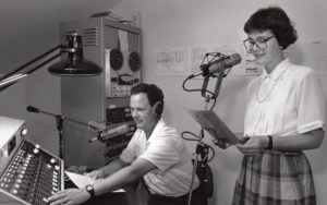 Vintage black and white photo of volunteer readers recording in sound studio
