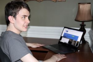 Volunteer working on his laptop at North Carolina Reading Service